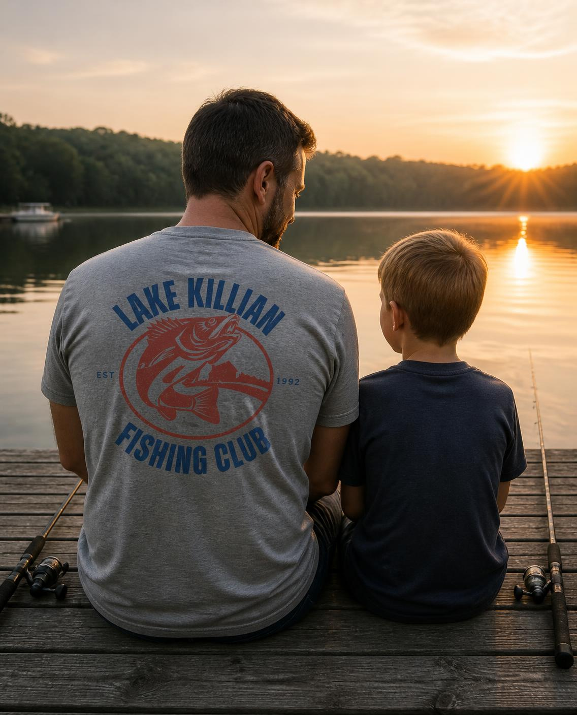 Dad and son fishing off a dock, dad wearing the Lake Killian Fishing Club tee